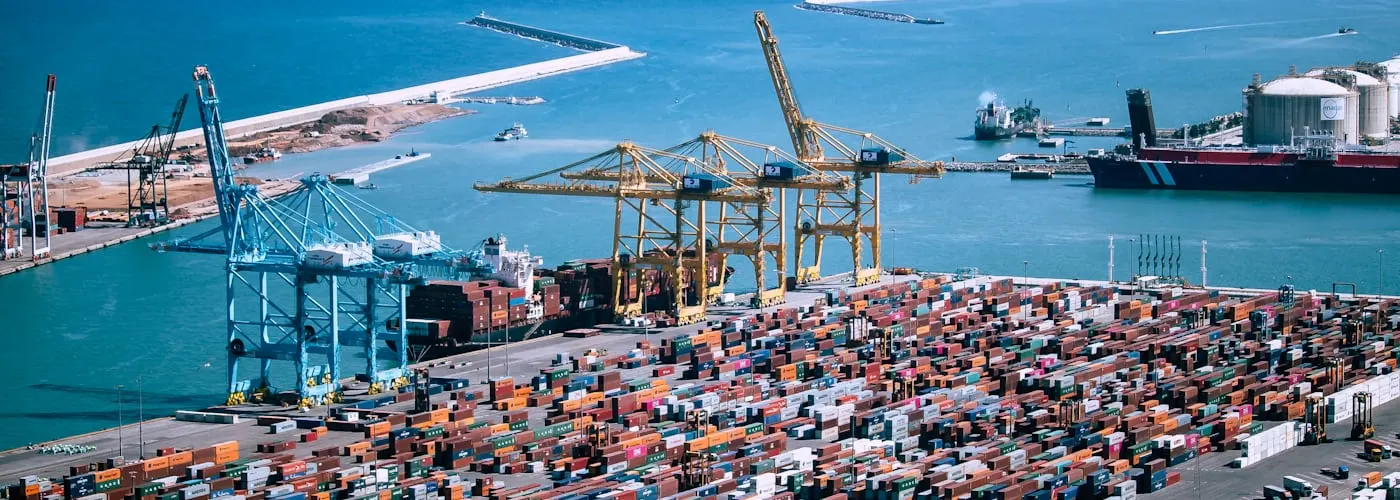 Aerial view of a container port with cranes and vessels